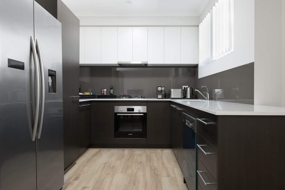 Enjoy cooking in our modern kitchen, fully equipped with a full-size refrigerator, oven, stovetop, and dishwasher.
