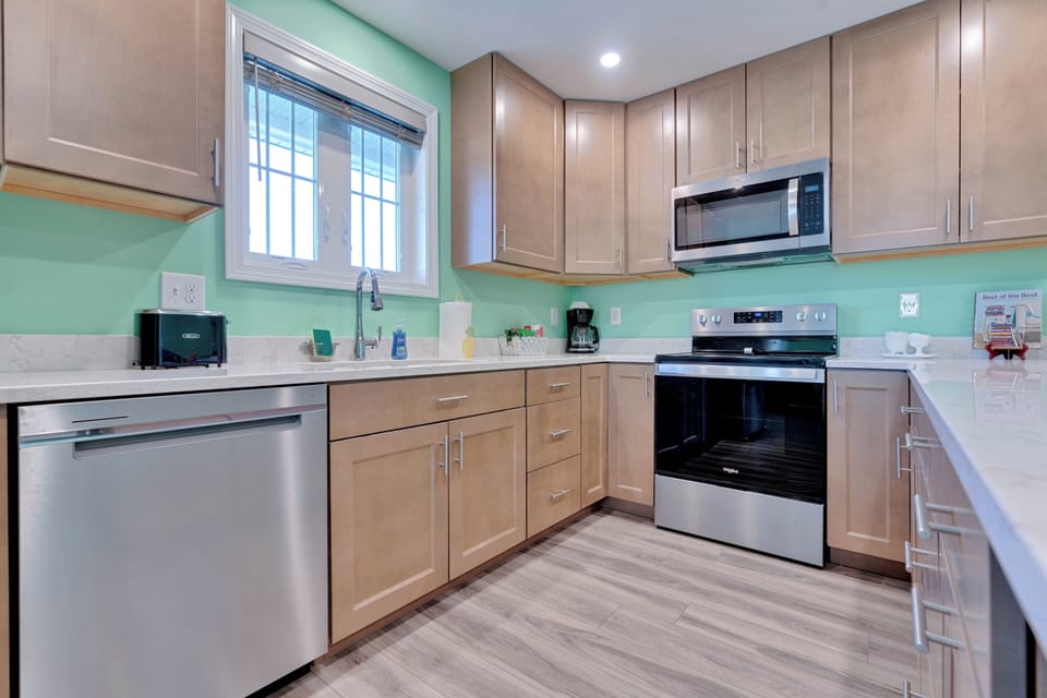 Unit A  - full modern kitchen 
Michelle said on her Sept 2024 VRBO review "Beautiful home and a great location. Great layout for the entire family to visit. Love that it has 3 full bathrooms. Being able to walk across the street to the beach was perfect. It was cool watching the trains go by too. The best part was since the house is not located near an intersection, the horns did not go off."