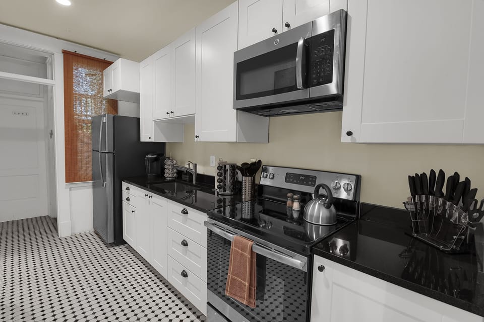 stove/oven, fridge, microwave, tea kettle, cooking utensils  