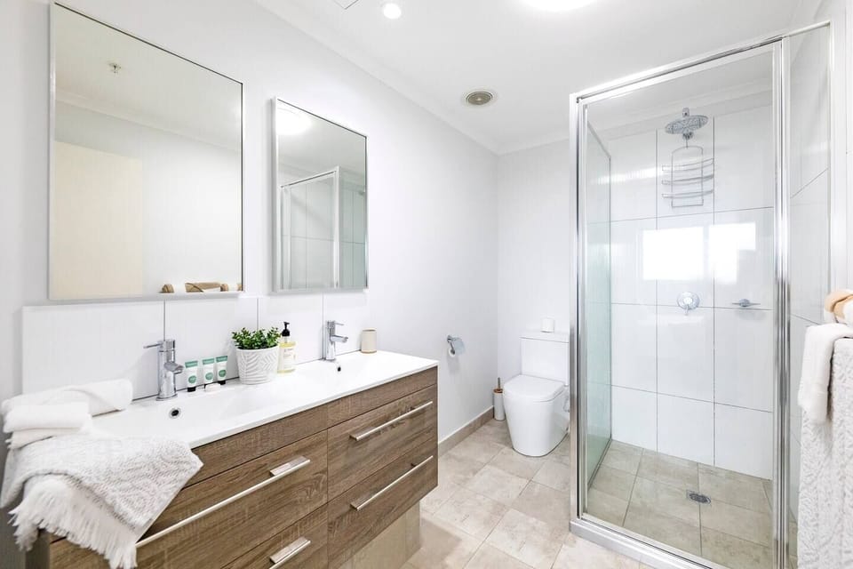 The master bedroom benefits from a modern ensuite with a shower, toilet and double basin.
