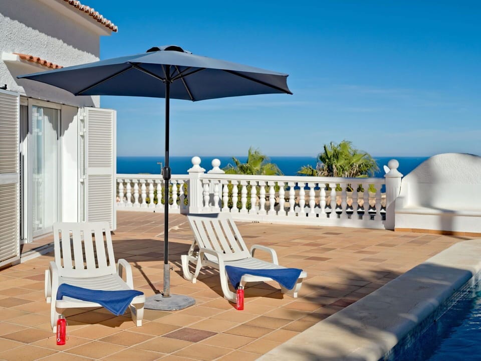 Sky, Water, Building, Property, Furniture, Azure, Seaside Resort, Shade, Outdoor Furniture, Architecture