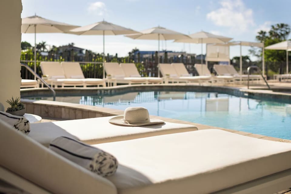 Sink into plush loungers and savor calm, warm pool days.