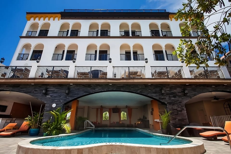 Dive into a stunning courtyard pool beneath elegant arches.
