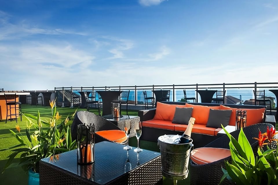 Sip champagne on the rooftop with sweeping sea views.