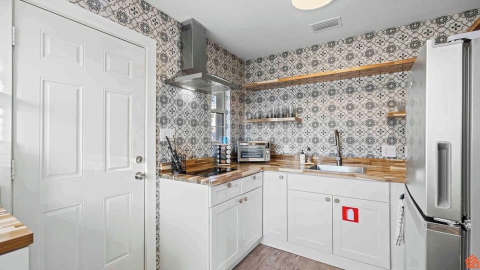 Fully equipped with modern appliances and plenty of counter space.