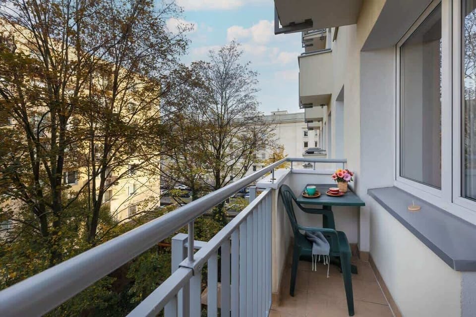 Spacious balcony with outdoor furniture. 