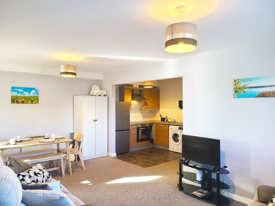 Open plan, modern kitchen, dining, lounge, TV and locally commissioned art.