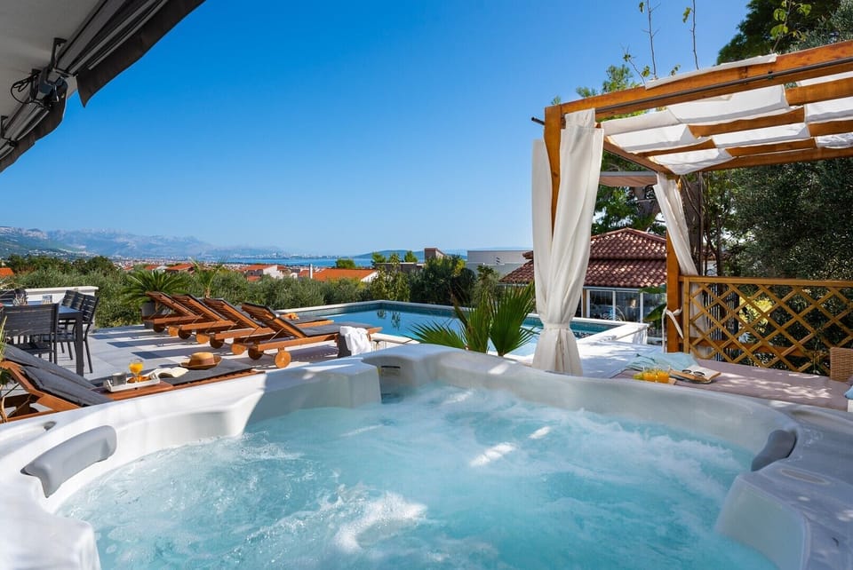 Private hot tub that overlooks pool area