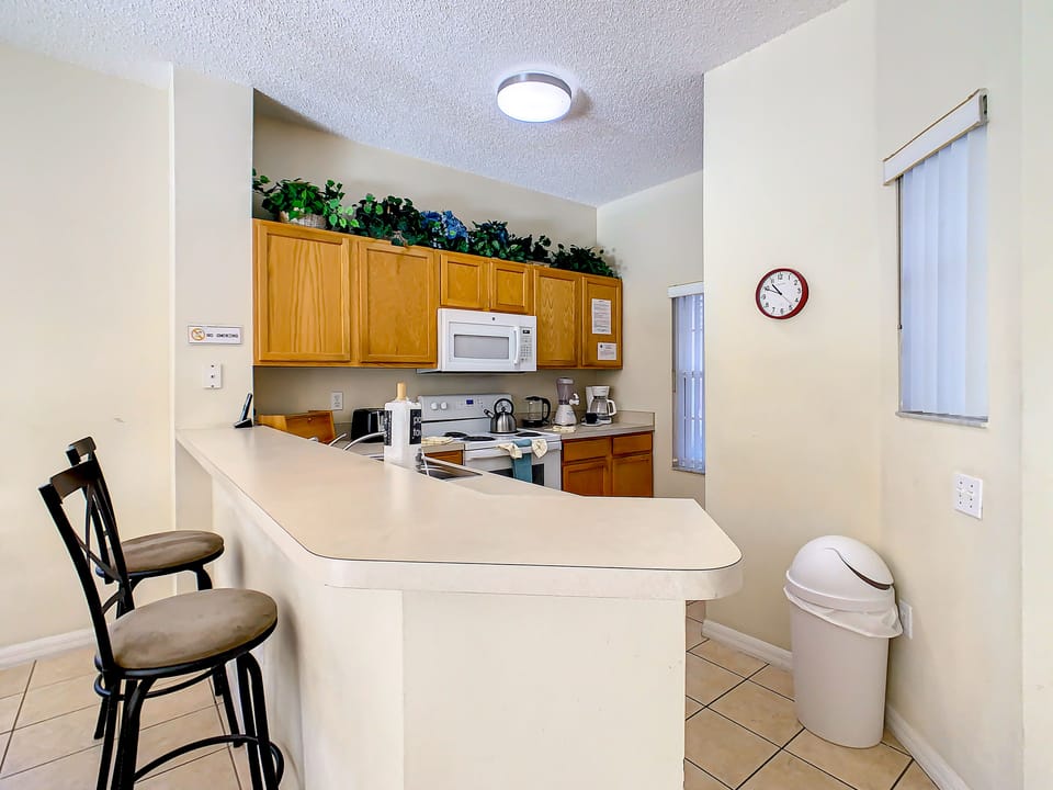 Open-concept kitchen with a breakfast bar and seating for casual dining.