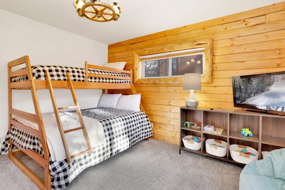 Peaceful cabin bedroom with plush bedding, and beautiful views—ideal for restful nights, cozy mornings, and a relaxing mountain escape.