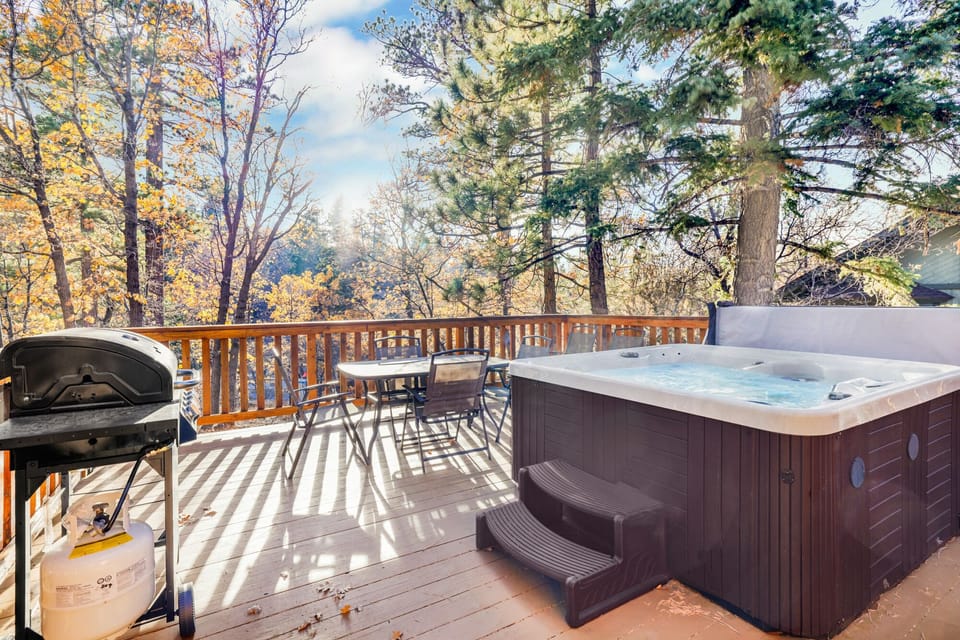 Outdoor area with a BBQ grill, relaxing hot tub, and spacious backyard, perfect for enjoying fresh air, gathering with friends, or unwinding under the open sky.