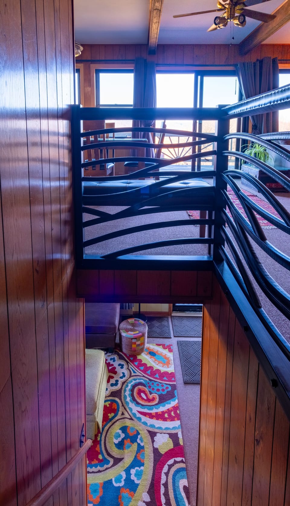 Stairway to lower level den / TV room. Hand forged railing by Lucas Warner.
