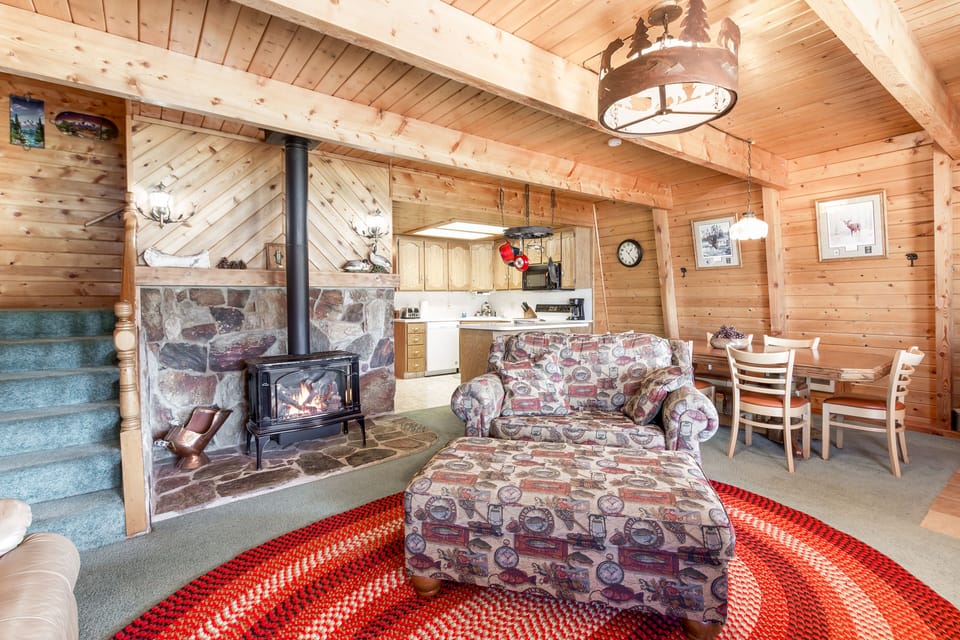 Cozy up by the sweet gas fireplace in the living room of Henry's Hatch Cabin, adding warmth and charm to your lakeside retreat with flickering flames and comfortable ambiance.