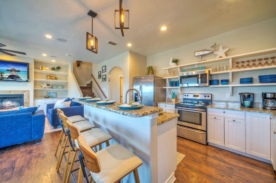 Fully equipped kitchen with barstool seating.