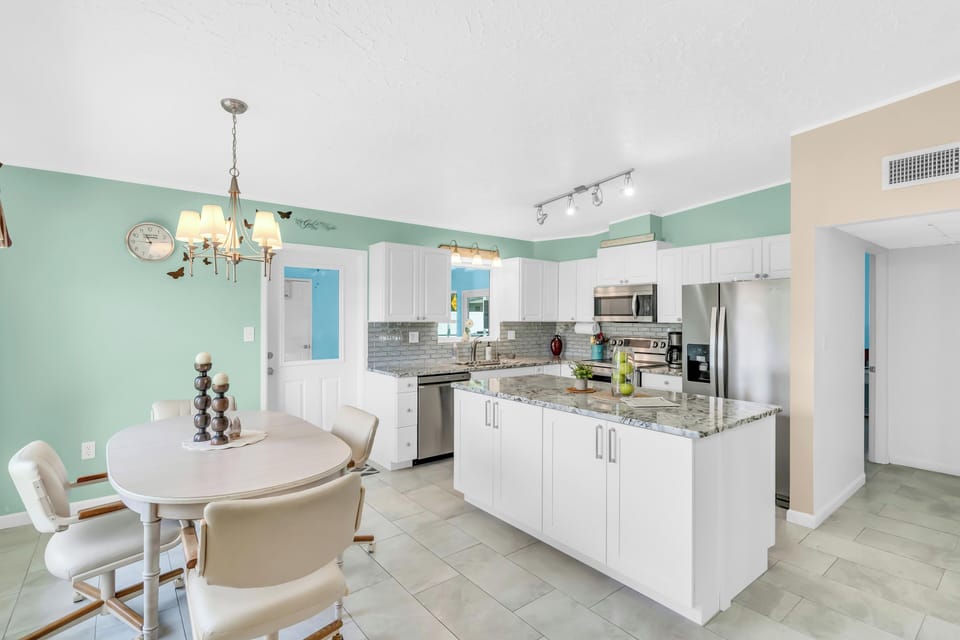 Full size kitchen and dining room area. The dining table has 4 seats.
