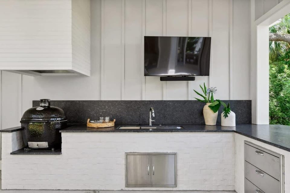 The outdoor kitchen , sink, and grill.
