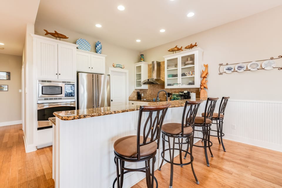 Your dream kitchen awaits with granite countertops, stainless appliances, and charming breakfast bar where morning coffee tastes even better.