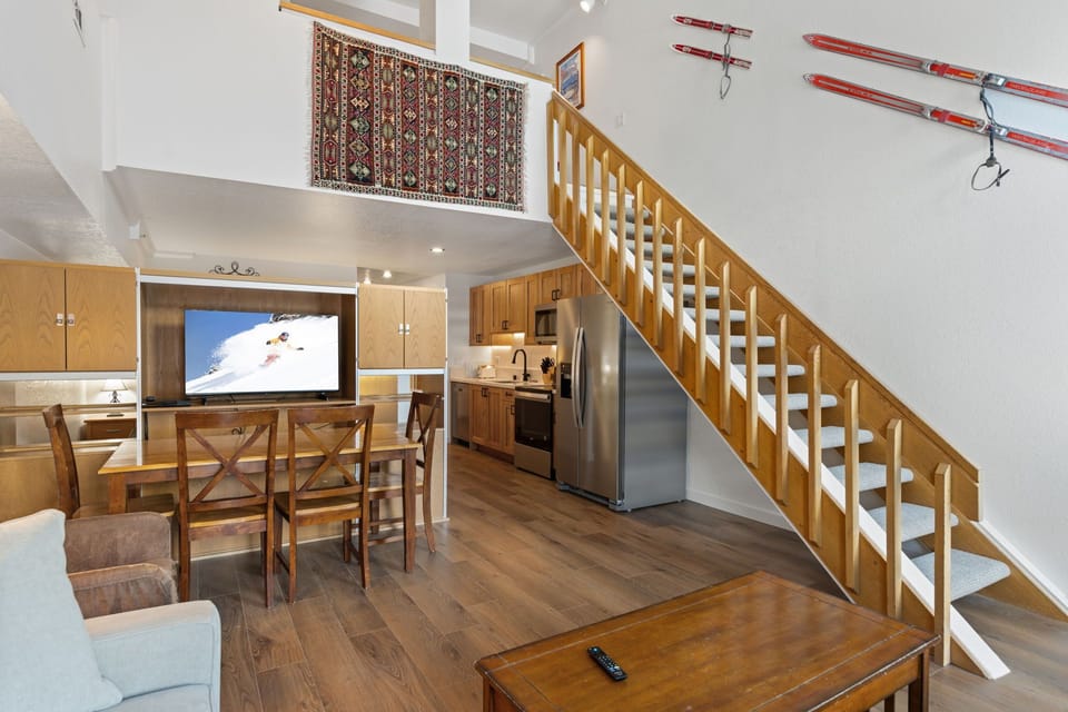 Cozy alpine retreat with soaring ceilings, warm wood finishes, and ski memorabilia adorning the walls. Your perfect mountain getaway awaits.