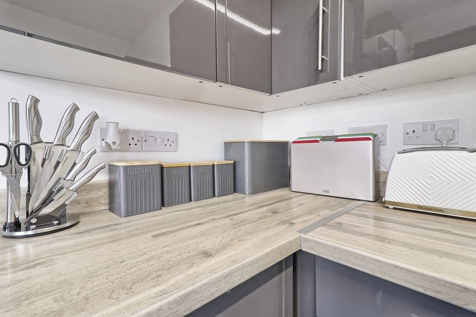 The kitchen is well stocked with essentials and cutlery, making cooking easy.