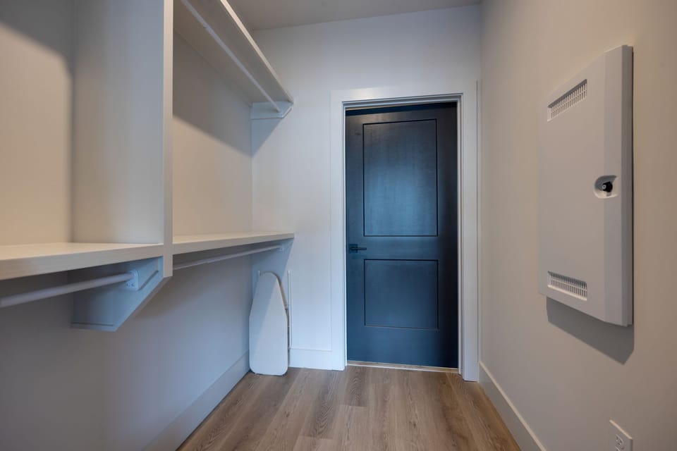 Primary Bedroom with King bed, smart TV, walk-in closet, and en-suite bathroom.