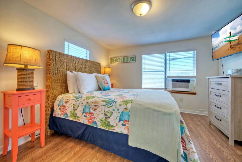 Bedroom 2 features a queen bed and a flat-screen TV.