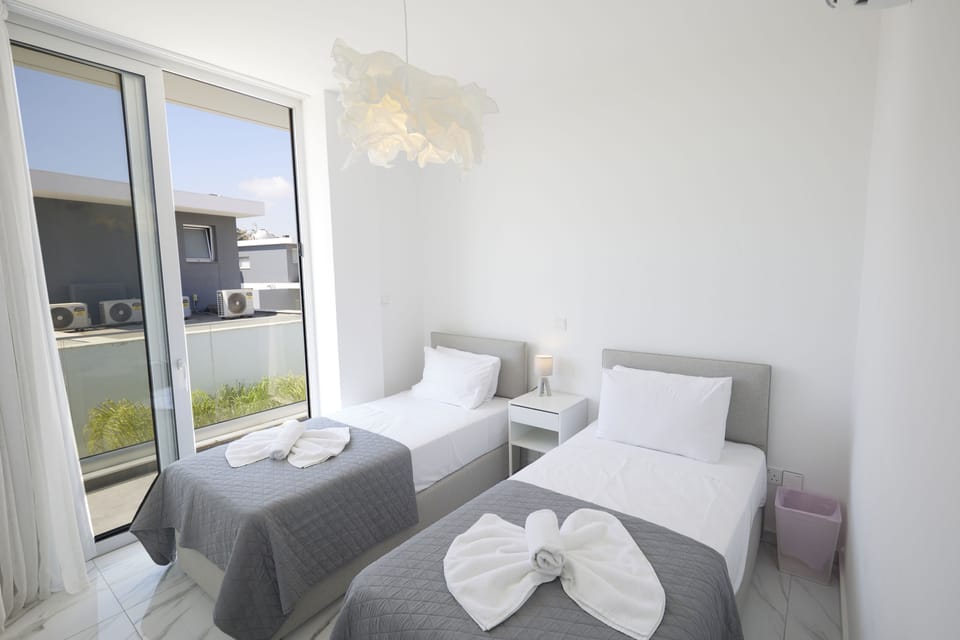 Bedroom 3 with two single beds and balcony access