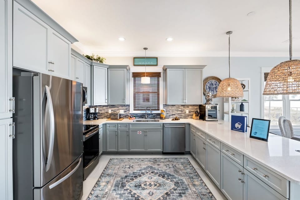 Your spacious kitchen awaits with gleaming countertops, modern appliances, and woven pendant lights creating the perfect spot for morning coffee or holiday feasts.