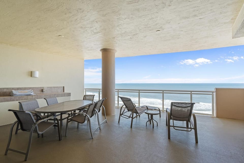 Spacious oceanfront patio with panoramic sea views and dining area
