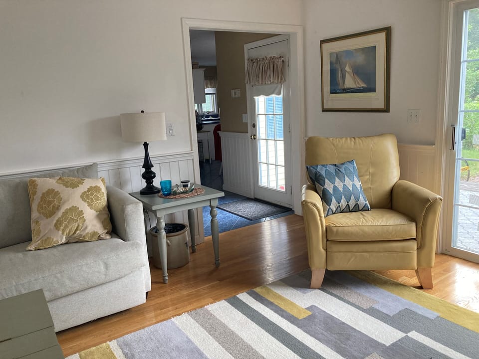 The living room. Deck to the right, hallway to kitchen and other rooms.
