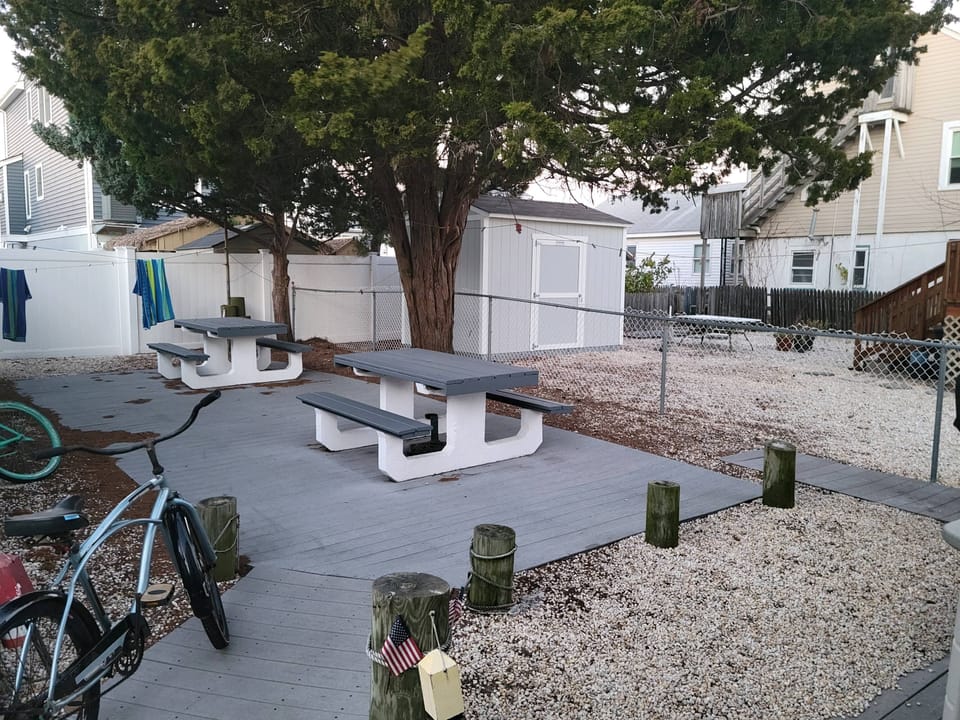 Backyard with picnic tables and gas barbecue 
