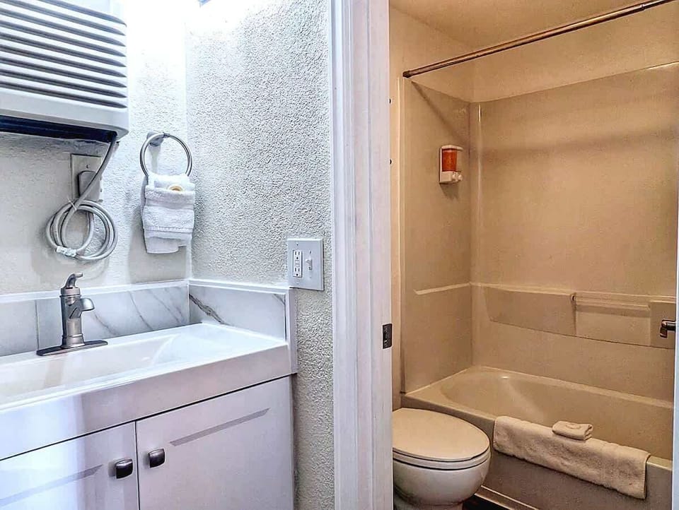 Bathroom overview with vanity, toilet, and tub-shower setup shown clearly for guest confidence.
