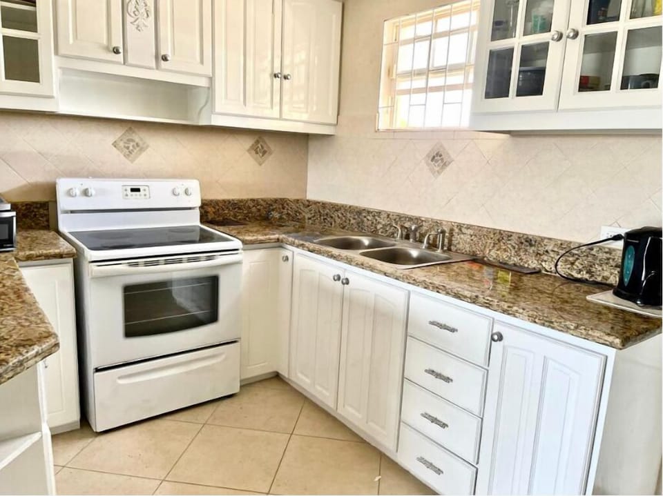 Fully equipped kitchen with fridge freezer and washing machine 
