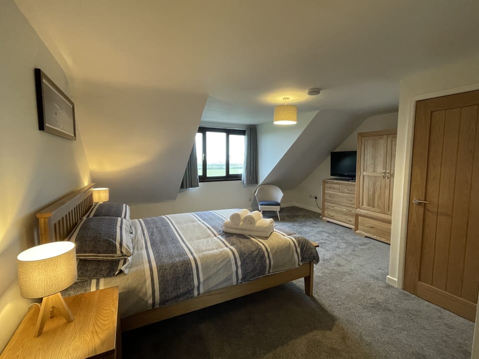 Master bedroom with views towards the church and the sea beyond