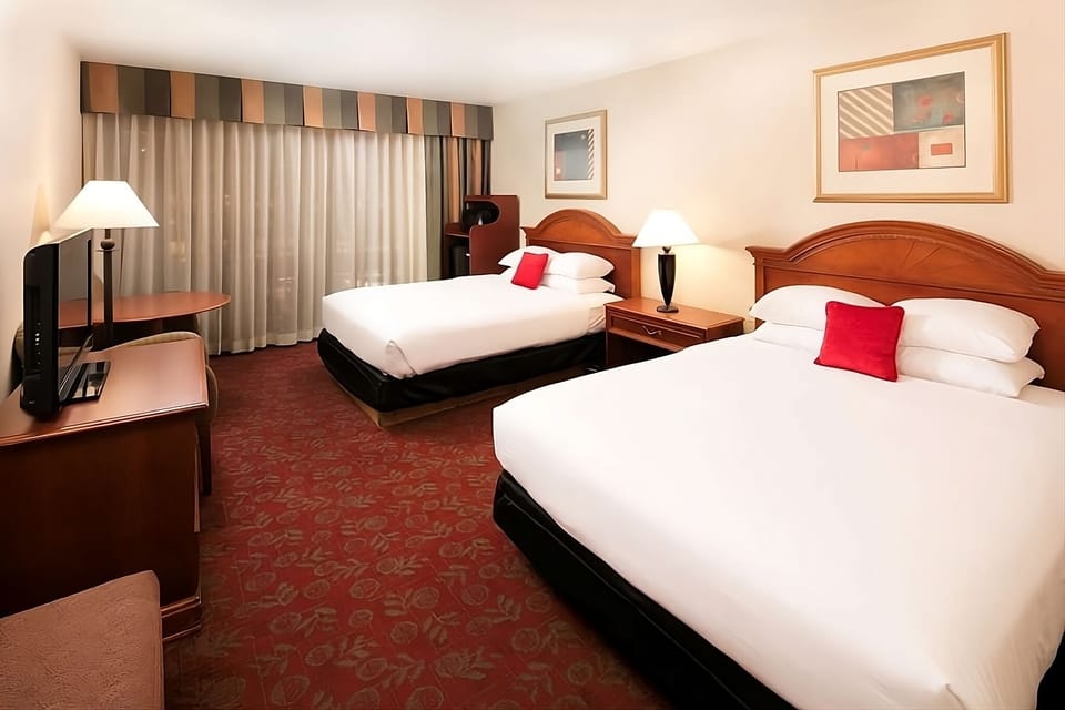 Unwind on crisp beds in a bright, spacious room.
