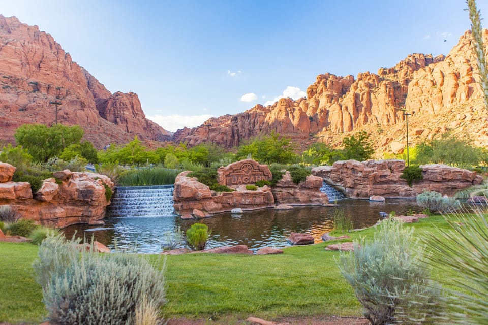 Stroll through lush gardens beside soothing waterfalls and red cliffs.