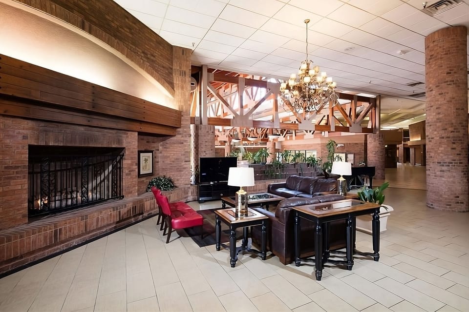 Gather comfortably in the open lounge with warm brick charm.