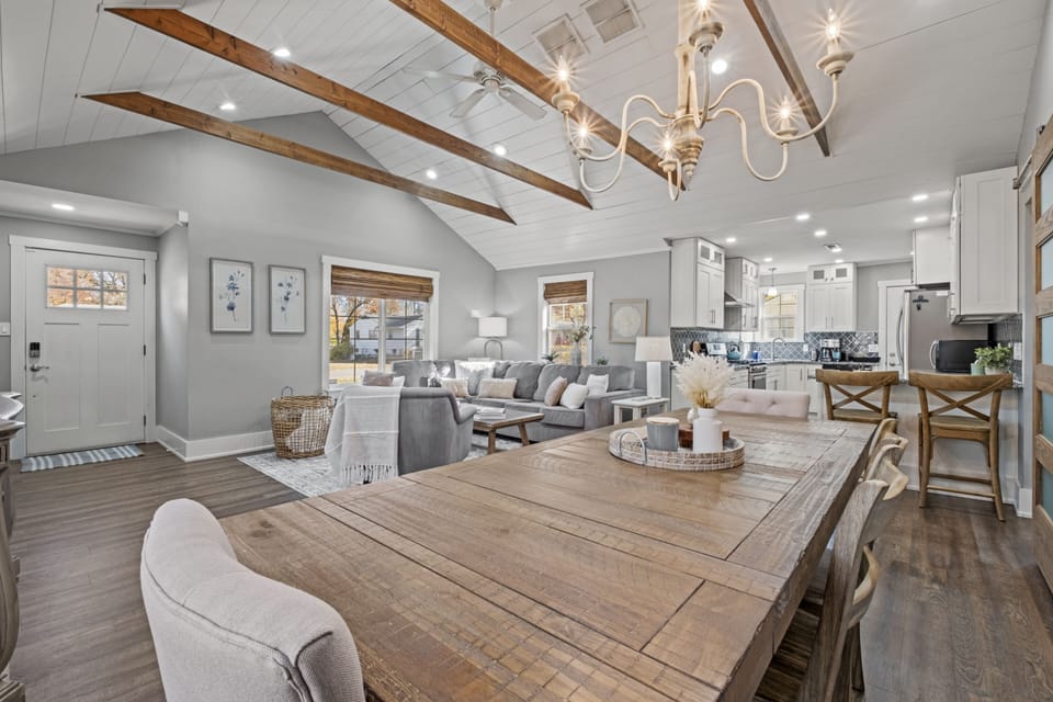 Spacious dining area with vaulted ceilings and exposed beams, offering an open flow into the living room and kitchen at Mission Outlook in Mission, KS.