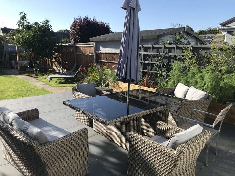 Large south west facing patio with chairs, loungers and gas bbq