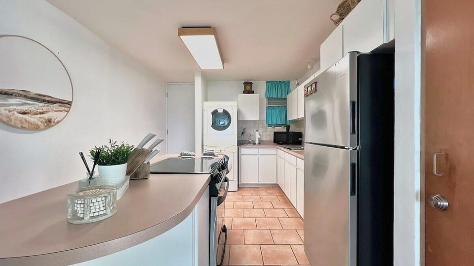 The washer and dryer are located in the kitchen area.