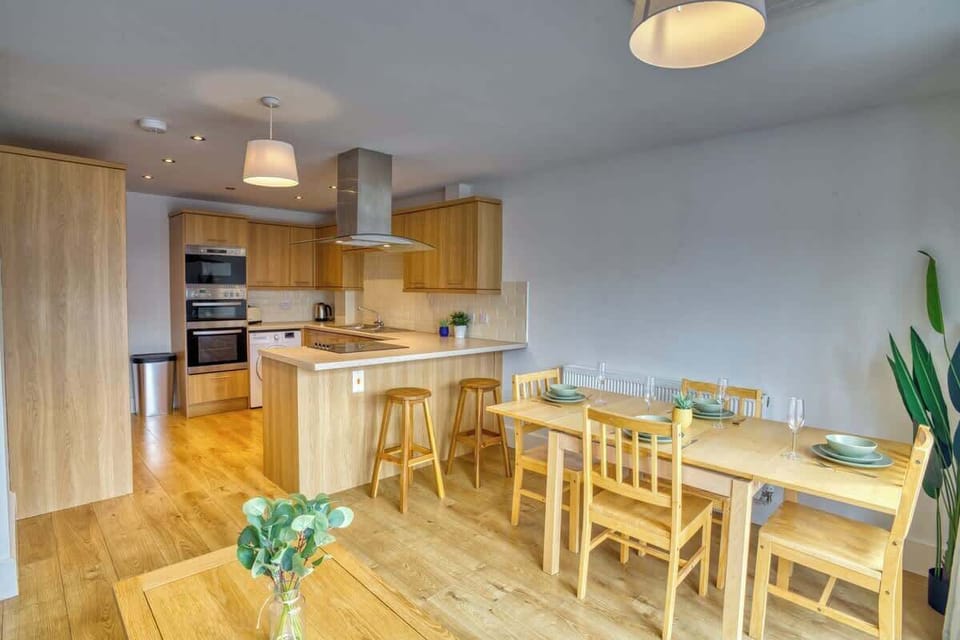 A sleek and spotless kitchen equipped with all essential amenities and a convenient washing machine-where functionality meets modern simplicity for effortless living.