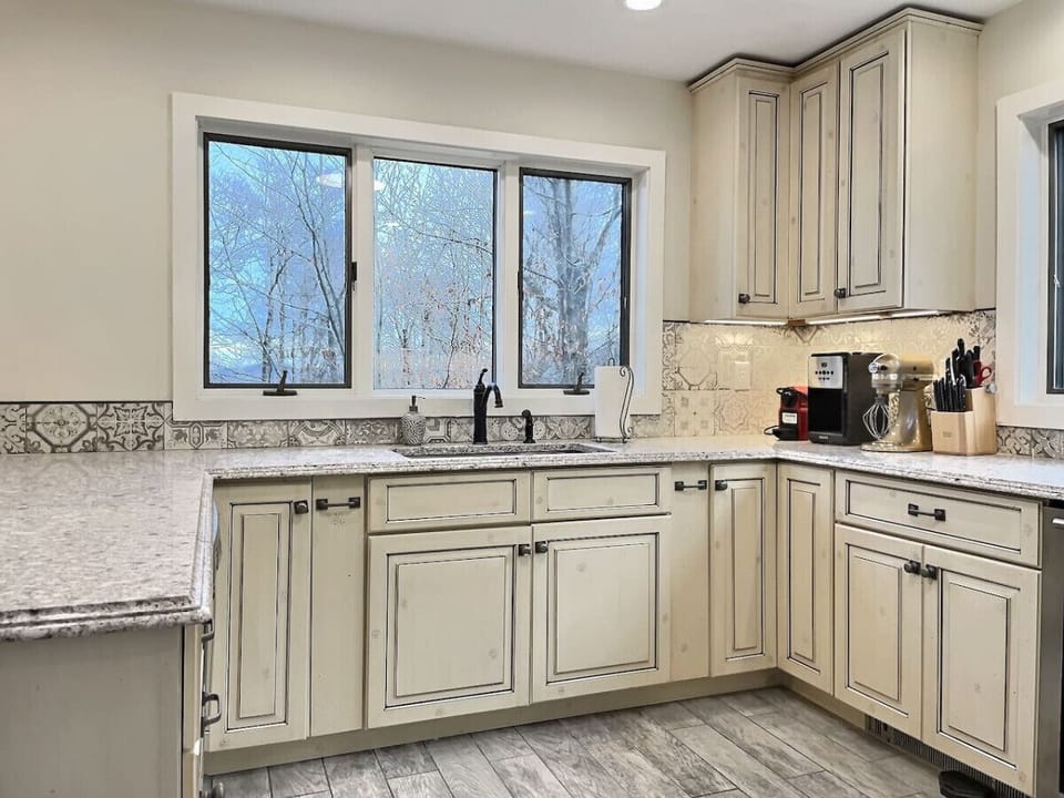 Step into elegance and sophistication in our kitchen, adorned with sleek white and black accents.