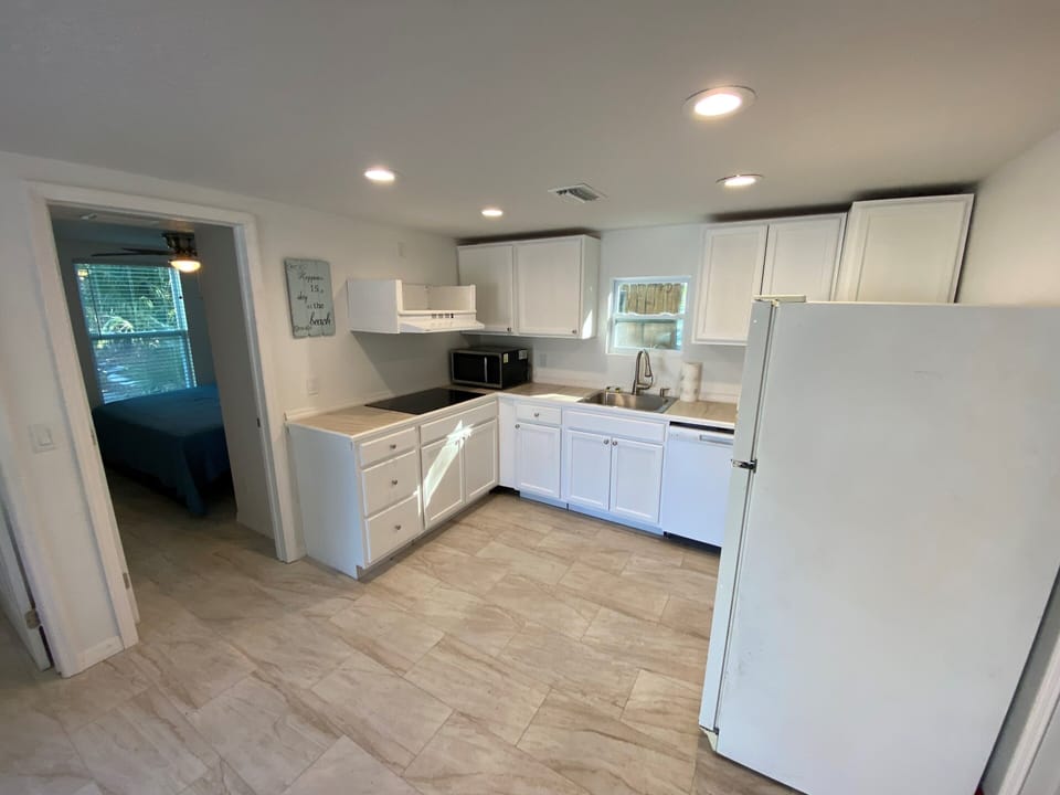View of kitchen from living room area looking into Bedroom 2
