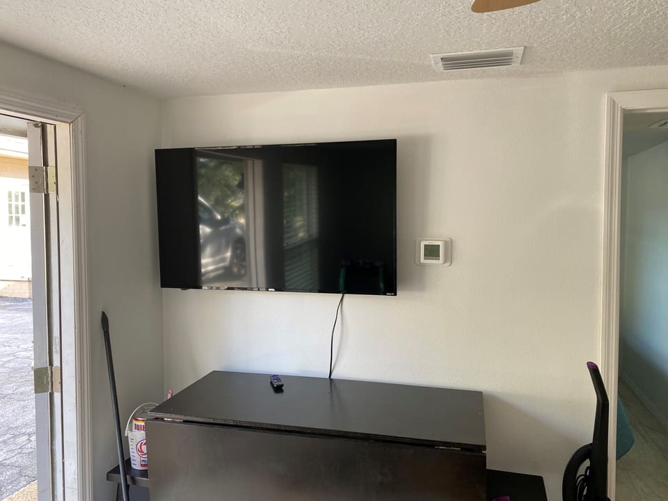 50-inch flat screen smart TV in living room with Sling TV news/sports