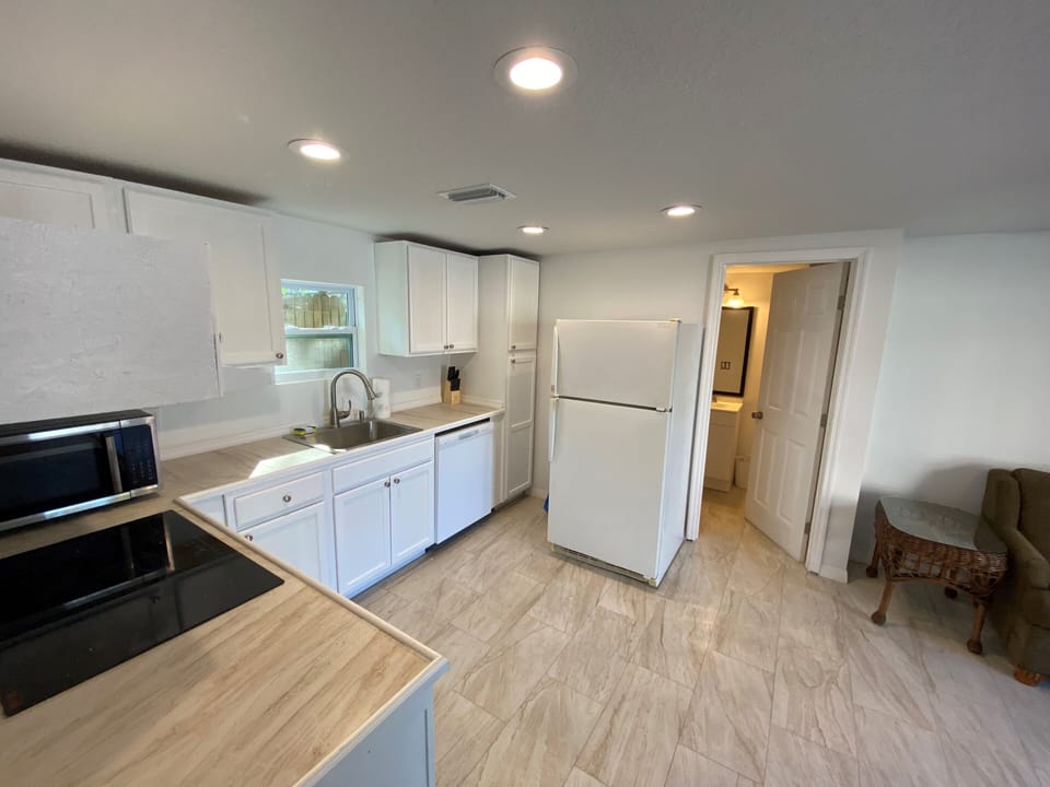 Kitchen with refrigerator, cooktop, dishwasher, and oven (microwave & air fryer)
