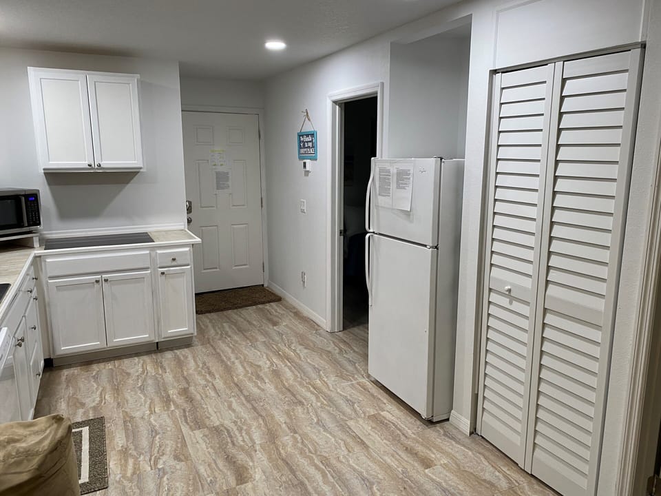 Pantry, refrigerator, looking towards entry