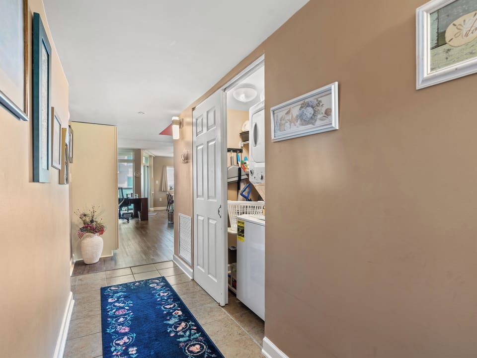 Bright hallway with in-unit laundry and warm, welcoming finishes