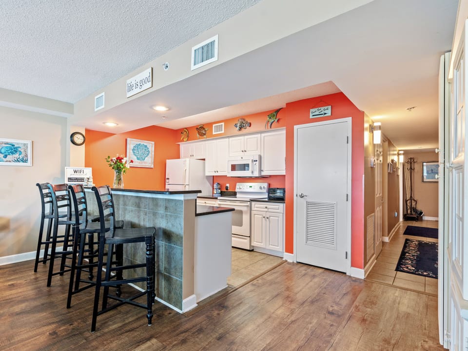 Bright open kitchen with breakfast bar seating for four