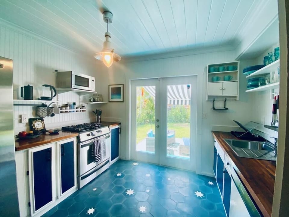 Full-size kitchen with gas stove that opens onto back yard