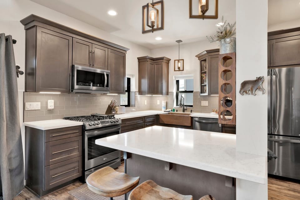 Fully equipped cabin kitchen with ample cabinetry, stove, fridge, microwave, and coffee maker—perfect for cooking meals, morning coffee, and feeling right at home on your stay.