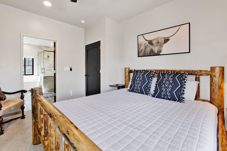 Peaceful cabin bedroom with plush bedding, and beautiful views—ideal for restful nights, cozy mornings, and a relaxing mountain escape.